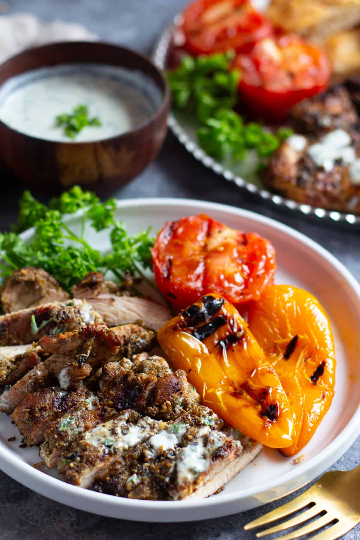 Serve grilled zaatar chicken with grilled vegetables and a herb yogurt sauce.