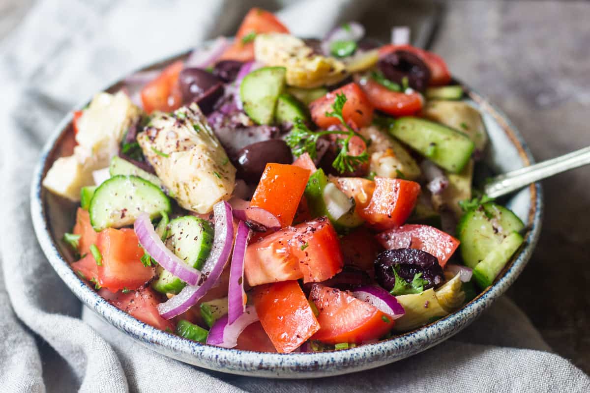 Serve Mediterranean cucumber and tomato salad in a bowl with extra dressing. 