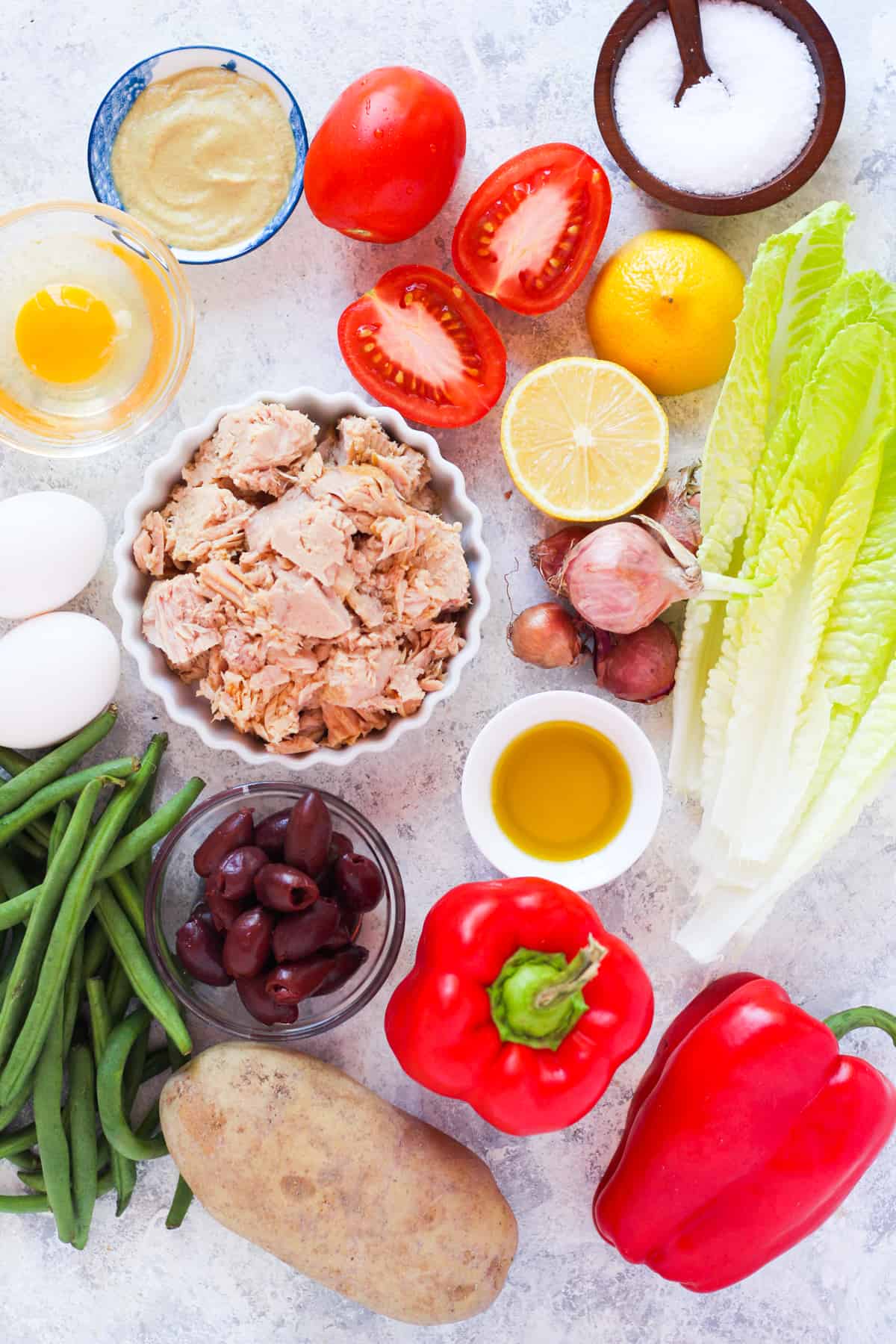 2 yukon gold potatoes peeled and cut into 1 ½ inch pieces
8 oz green beans
4 large hard boiled eggs
▢1 head lettuce washed and chopped
2 cans tuna in olive oil drained
½ red bell pepper sliced
1 cup nicoise olives or kalamata olives
2 roma tomatoes cut into large pieces
1 shallot sliced