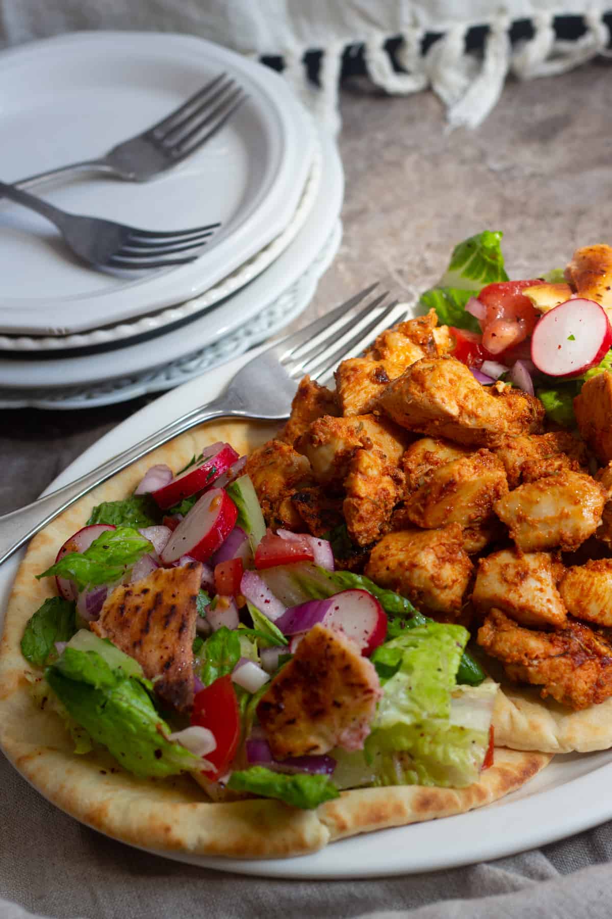 A platter of shish tawook on a brown surface. 