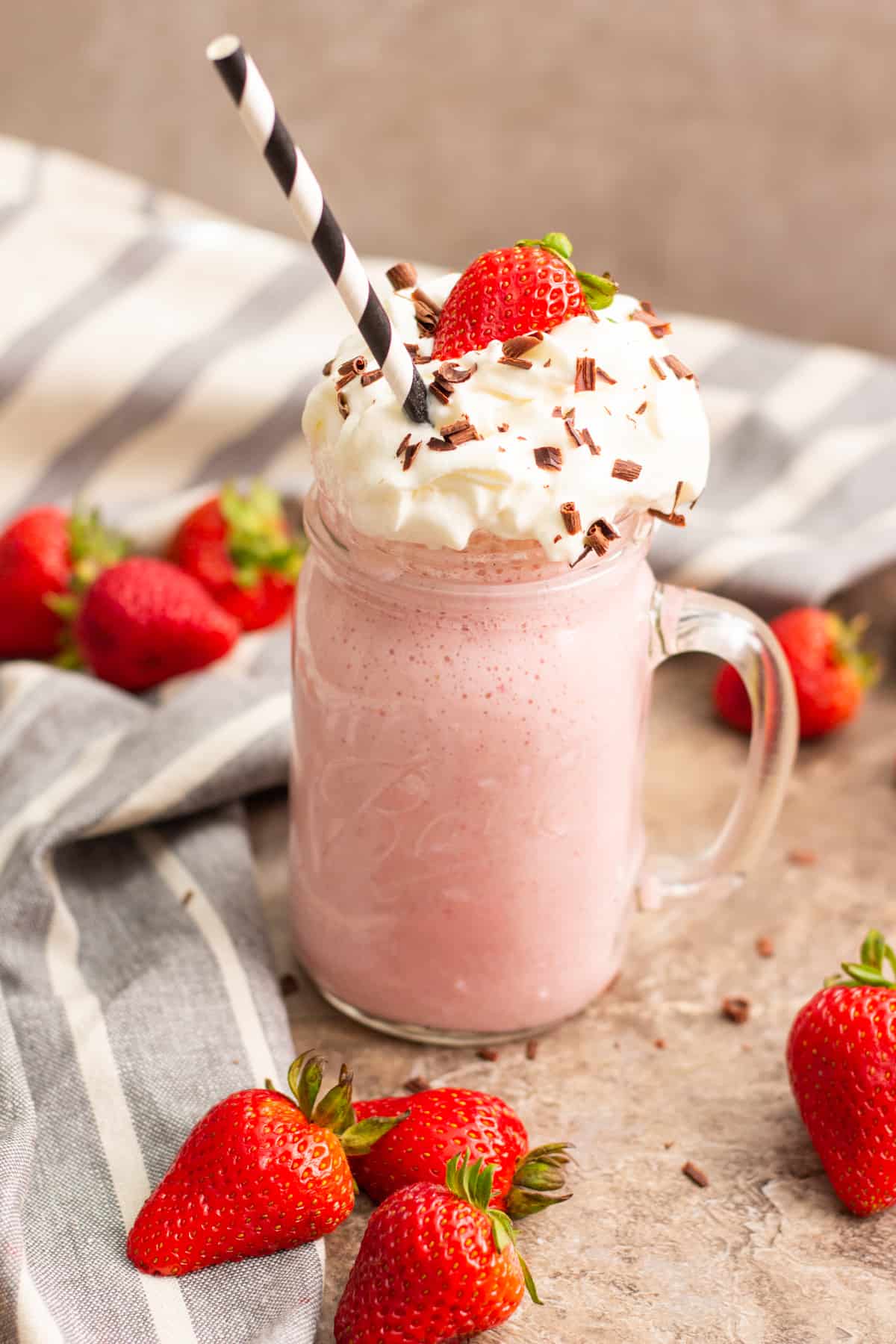 Strawberry milkshake made with fresh strawberries is an absolutely perfect drink! Learn how to make milkshakes that taste amazing. Real strawberries play a big role in this shake, no syrup or additional flavoring is needed. This is the best strawberry milkshake you've every had, it's creamy, rich and oh-so-good!