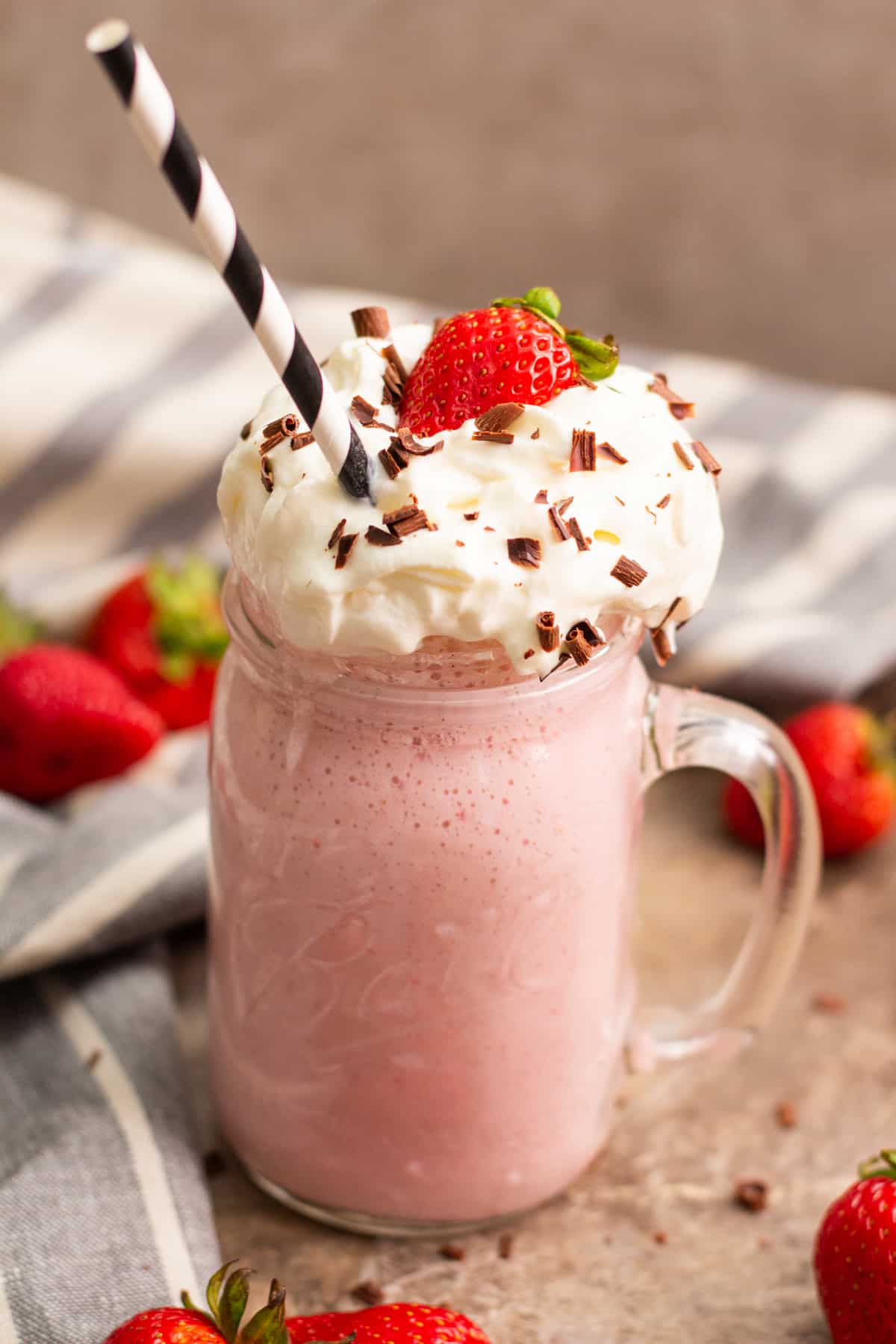 strawberry milkshake topped with whipped cream.