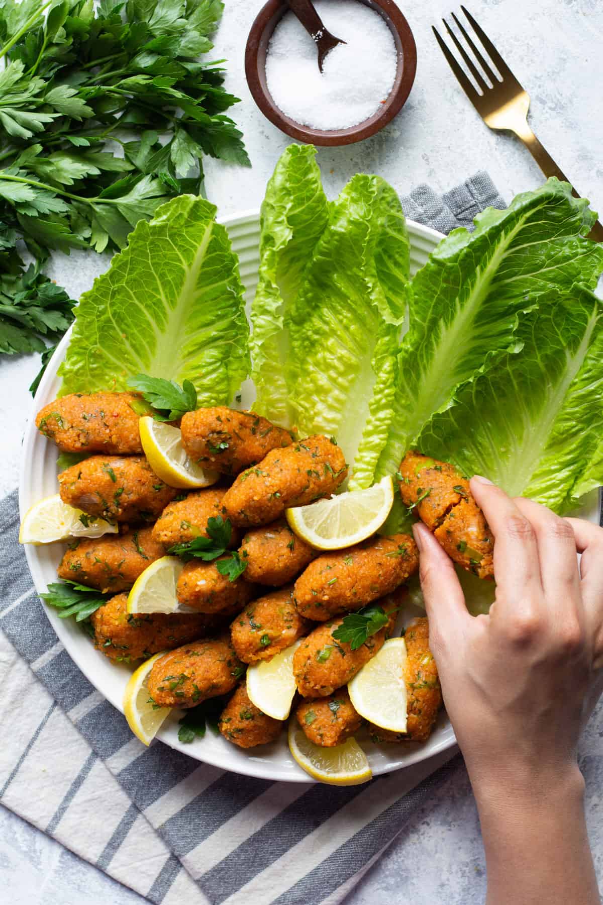 These vegan lentil meatballs are a Turkish classic. Made with red lentils and bulgur, these meatballs are usually served with lettuce and herbs.