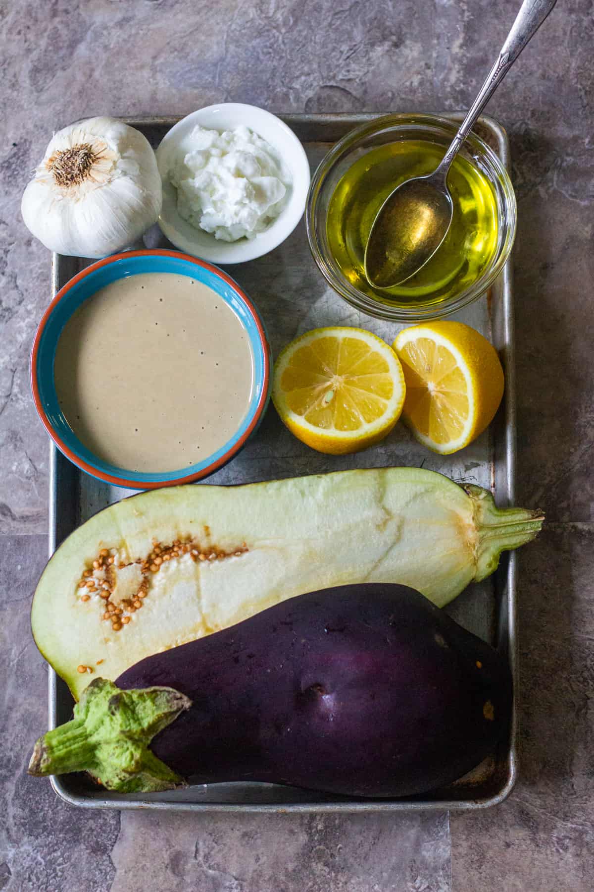 Baba Ganoush ingredients are eggplants, tahini, garlic, yogurt, lemon juice and olive oil. 