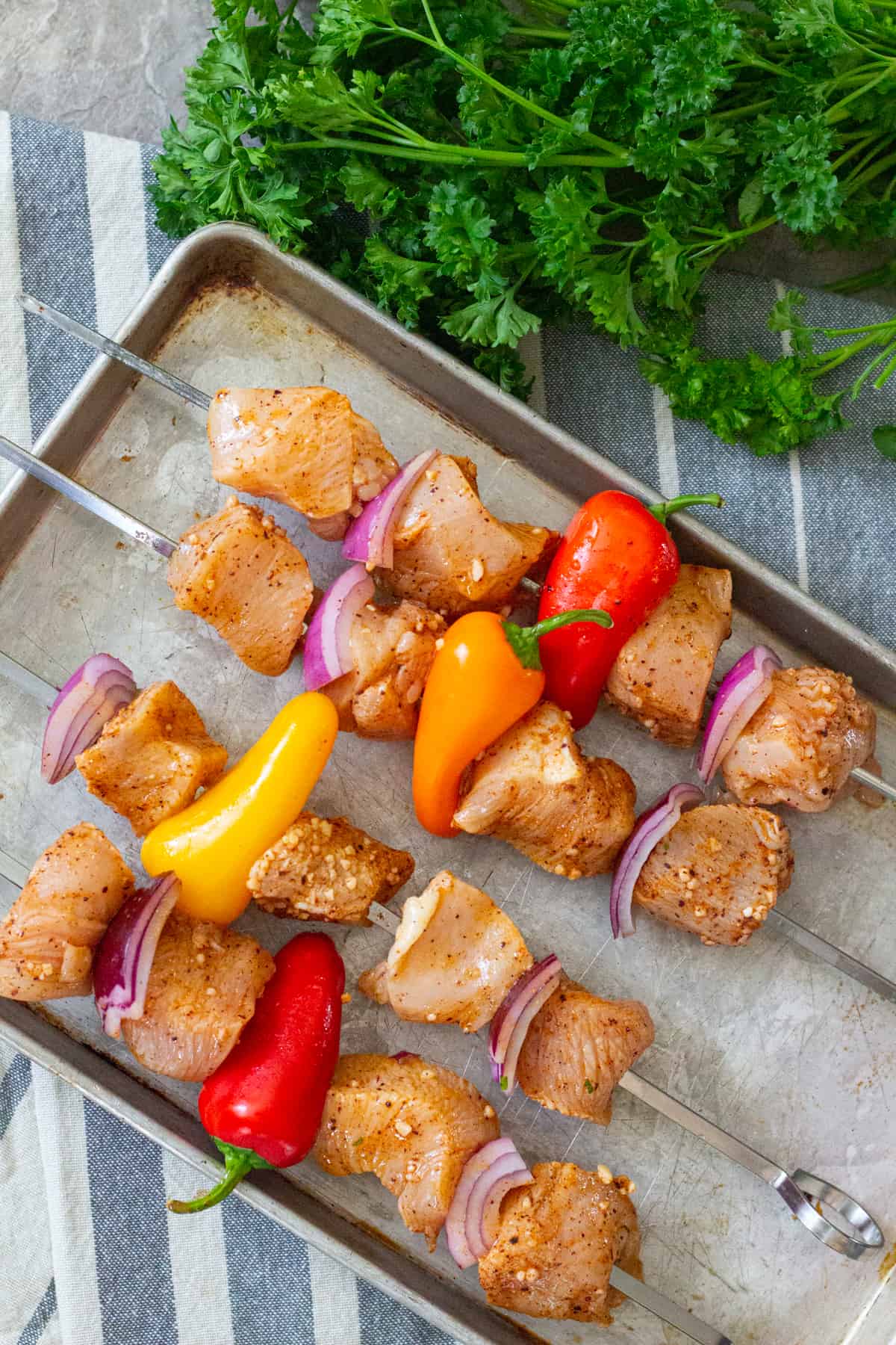 Thread marinated chicken on the skewers and start grilling. 