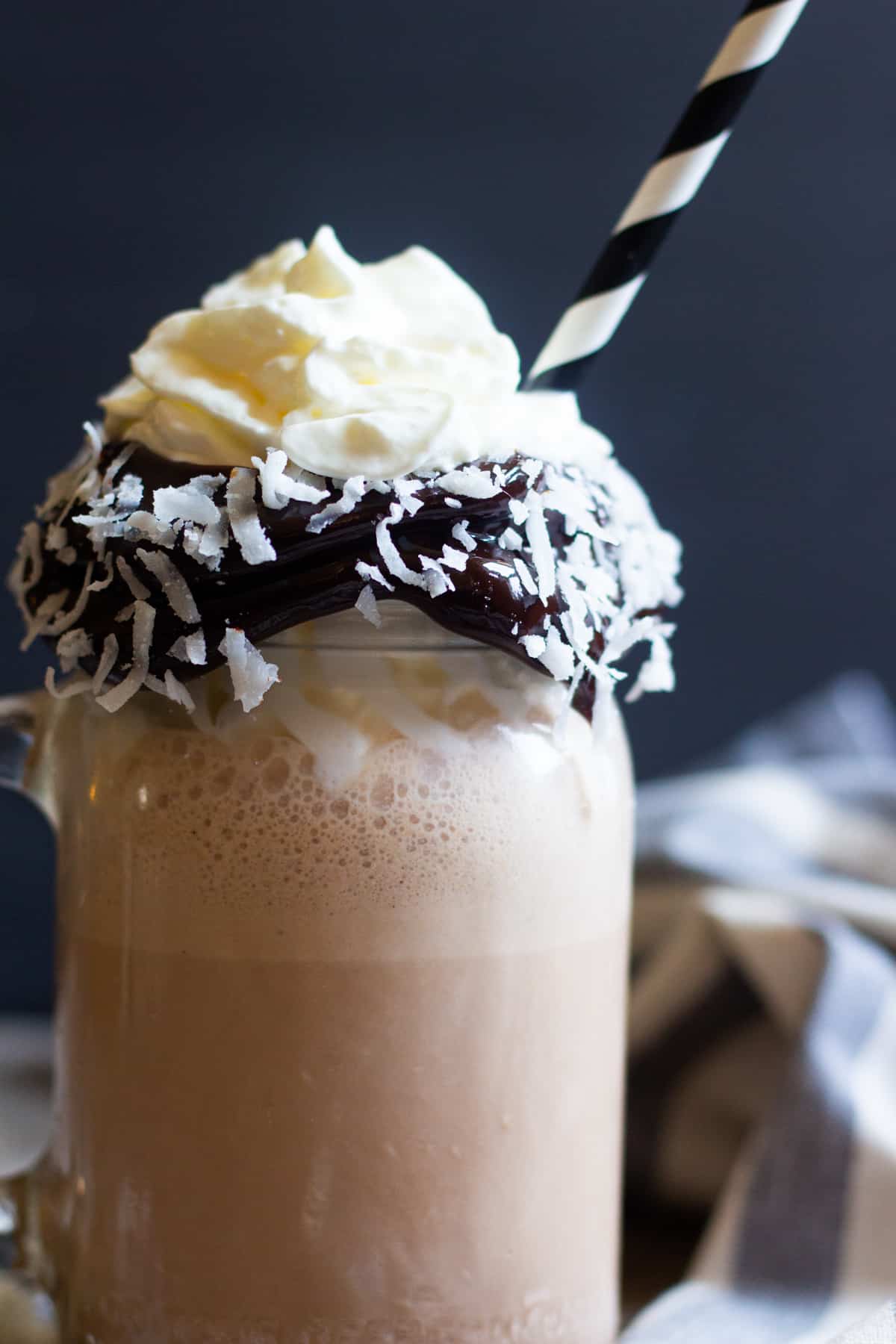 An easy coconut milkshake recipe served with whipped cream is perfect for summer.