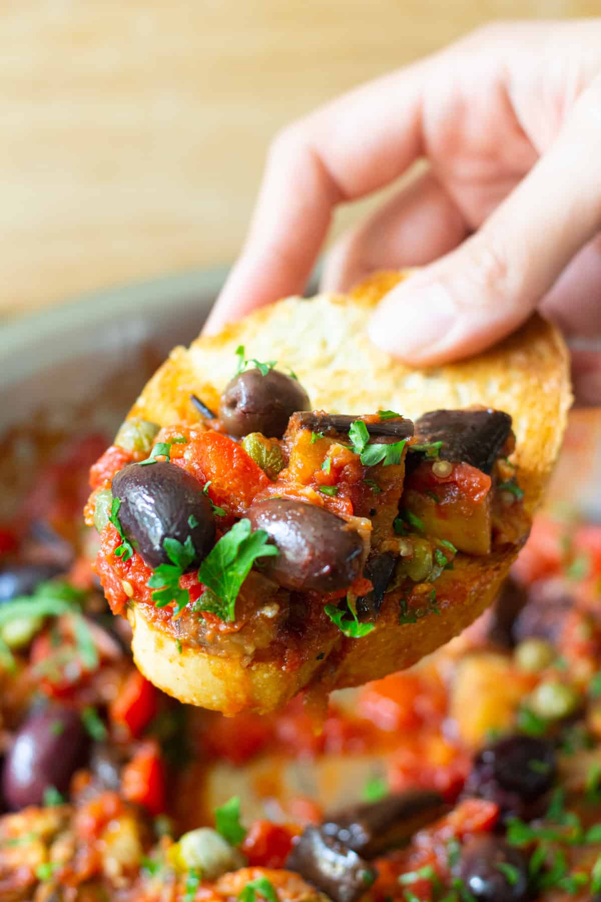 A piece of toasted bread topped with capunata.