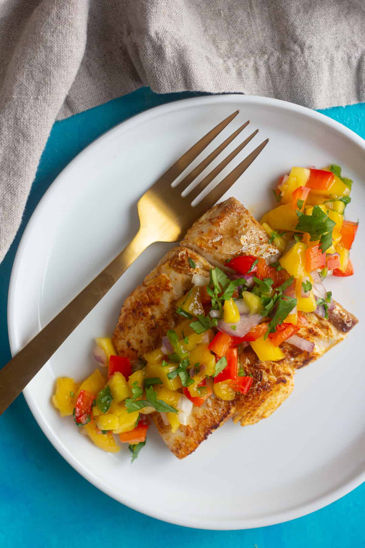 Learn how to grill Alaska halibut perfectly at home. Serve grilled halibut with spicy mango salsa for a celebration of flavors. 