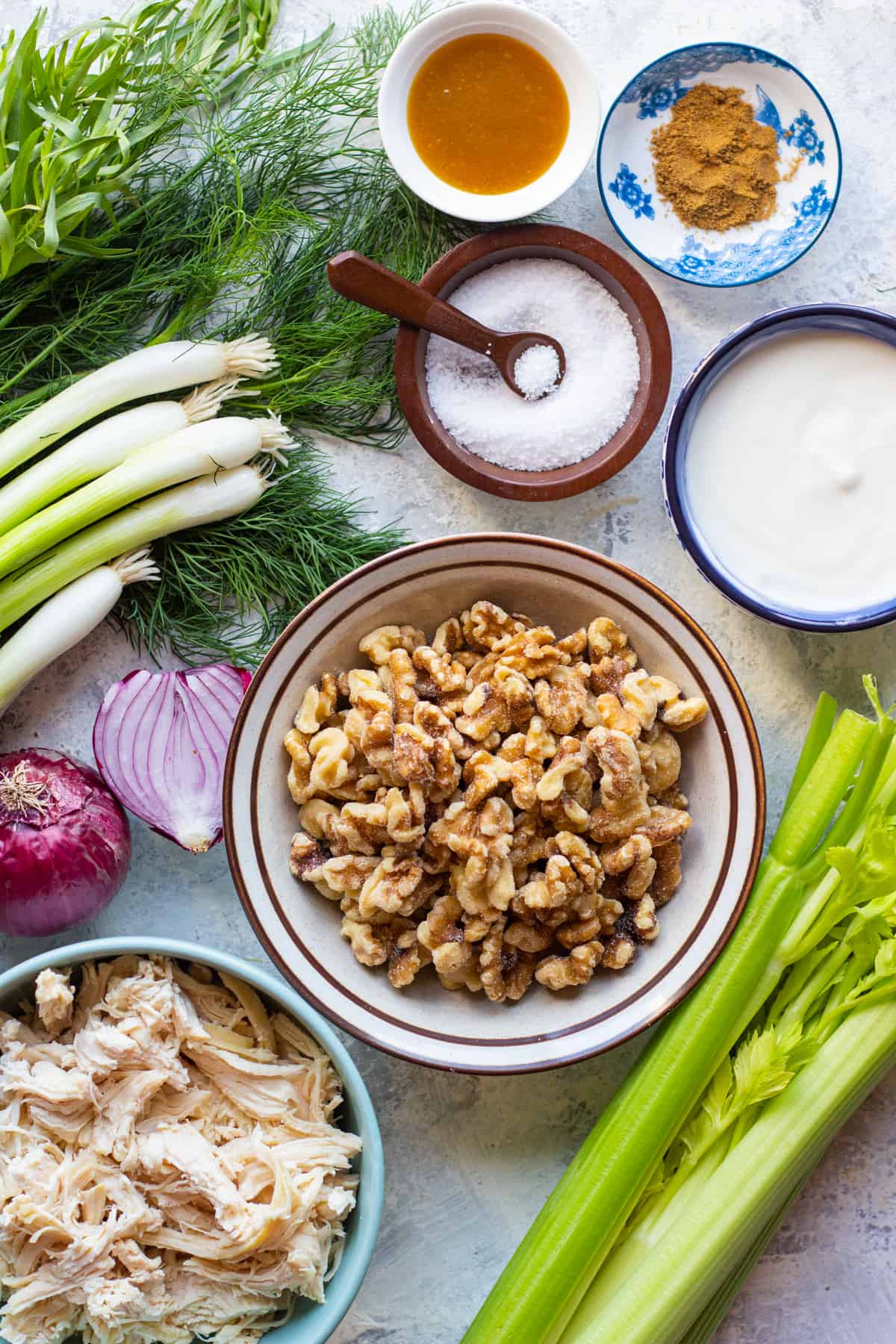 To make light chicken salad you need shredded chicken, walnuts, vegetables, celery and onion.