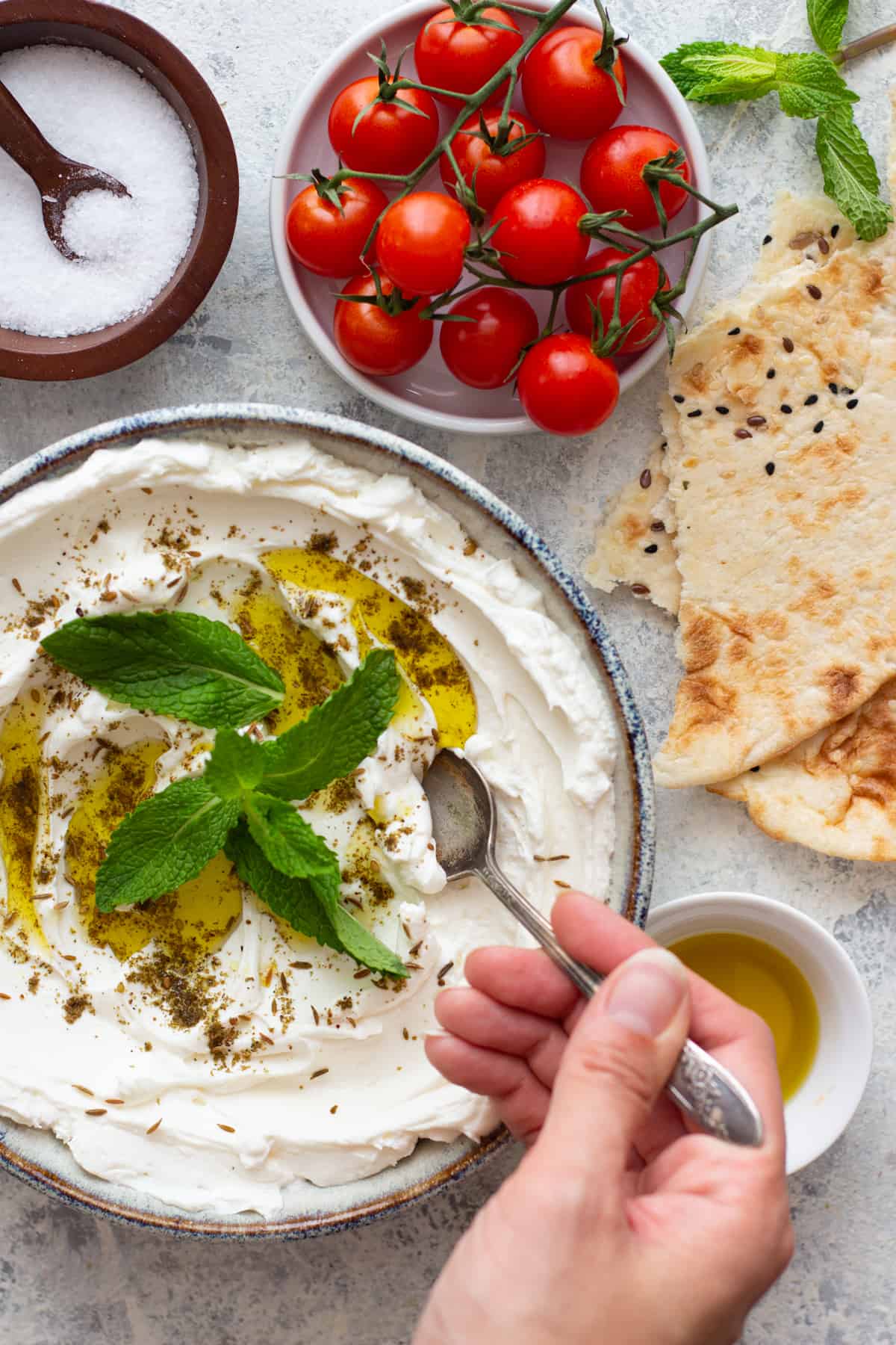 A bowl of labneh topped with zaatar and olive oil.