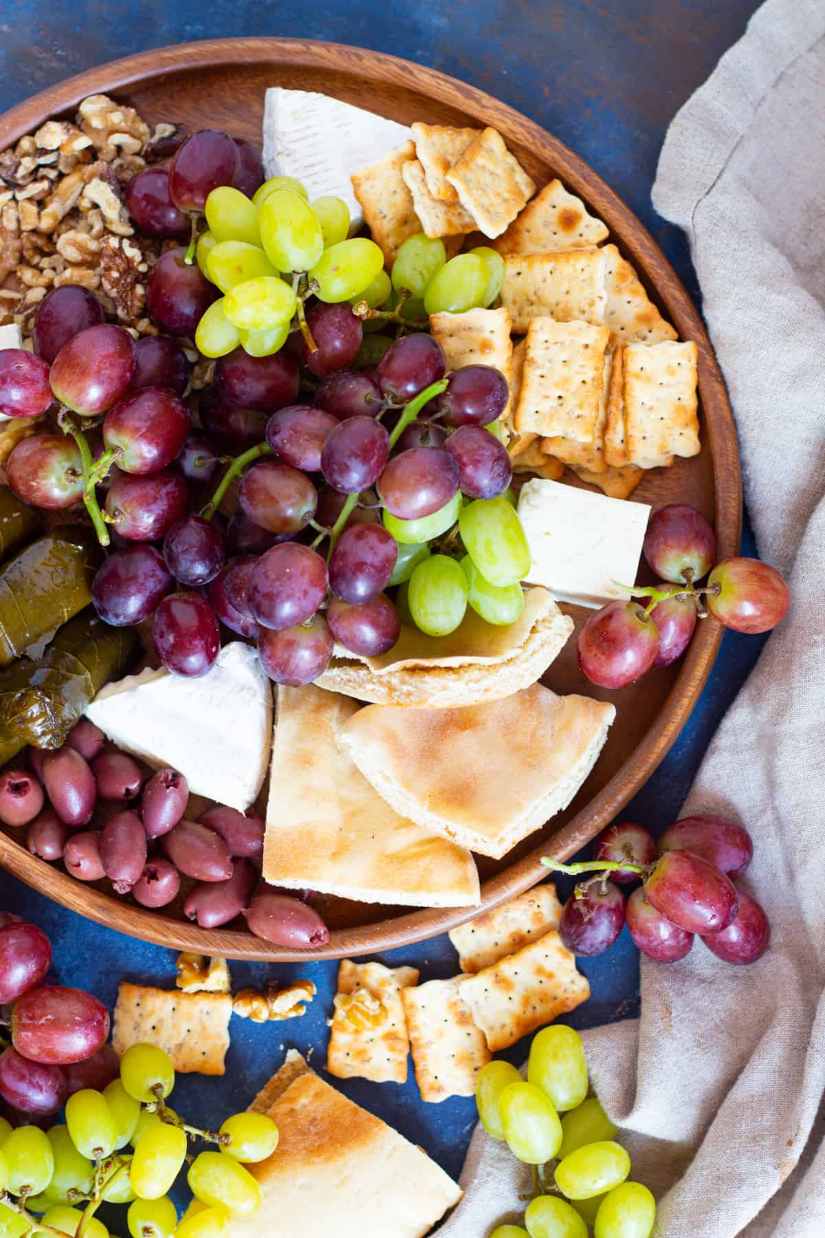 Add pita and crackers to the appetizer board. 