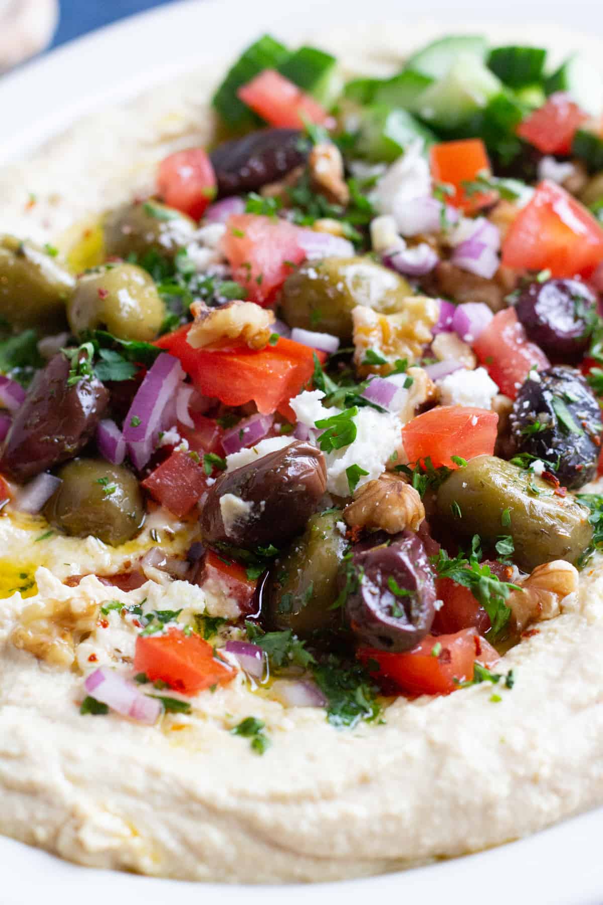 This loaded hummus recipe with all the fixings is ready in 15 minutes! Creamy hummus is topped with delicious toppings and served with pita!
