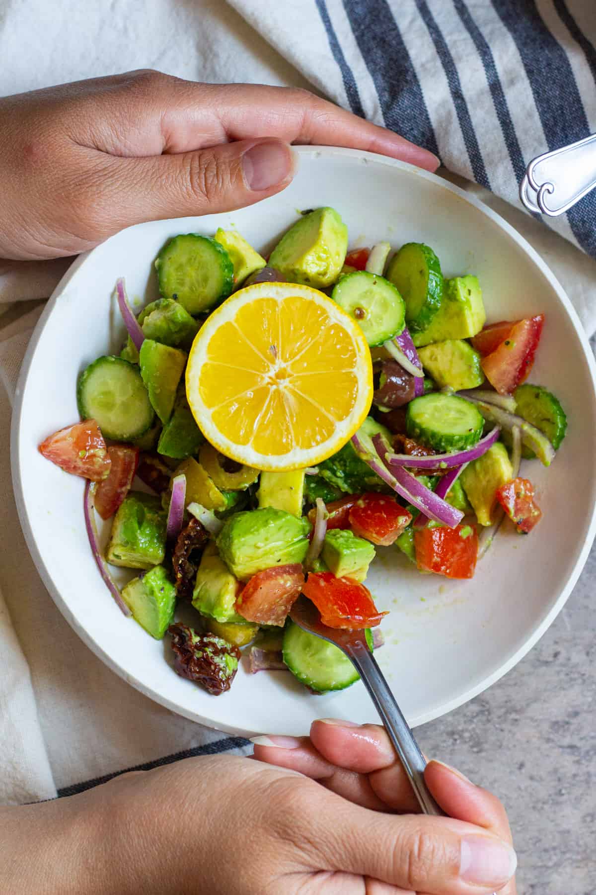 This cucumber tomato avocado salad is perfect for any day of the week. This easy and tasty salad comes together in 15 minutes and is full of flavor thanks to sun dried tomatoes and olives. 
