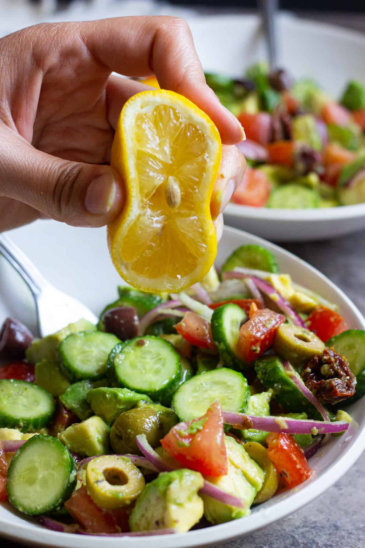 This cucumber tomato avocado salad is perfect for any day of the week. This easy and tasty salad comes together in no time and is full of flavor thanks to sun dried tomatoes and olives. 