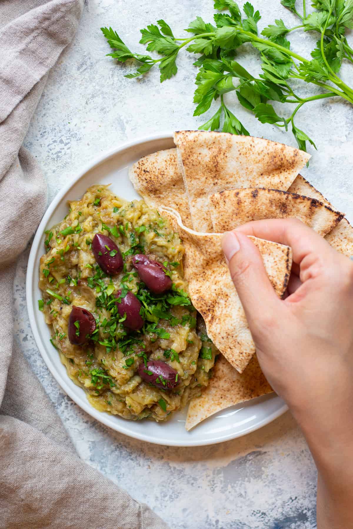 Melitzanosalata is a Greek eggplant dip that's made with eggplant, garlic and lemon juice. You can serve this eggplant appetizer as a part of a mezze platter with some pita. 
