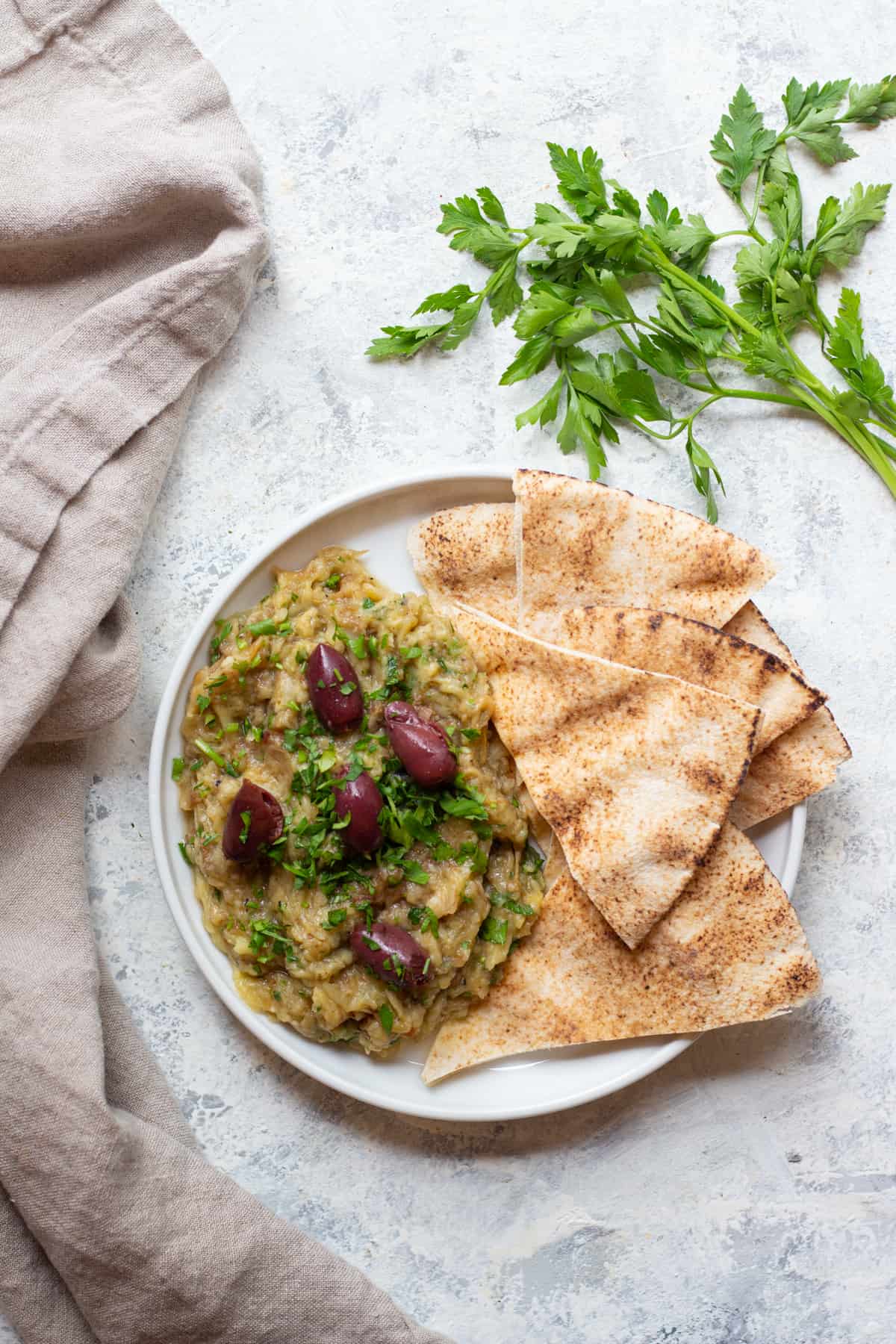 Melitzanosalata is a Greek eggplant dip that's made with eggplant, garlic and lemon juice. You can serve this eggplant appetizer as a part of a mezze platter with some pita. 