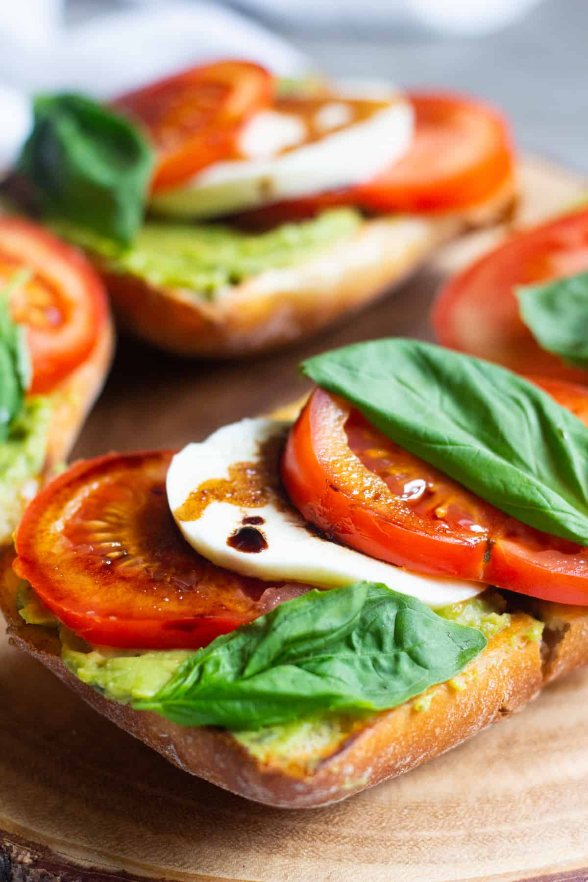 Italian bread with avocados, tomatoes and mozzarella. Topped with balsamic reduction and basil.