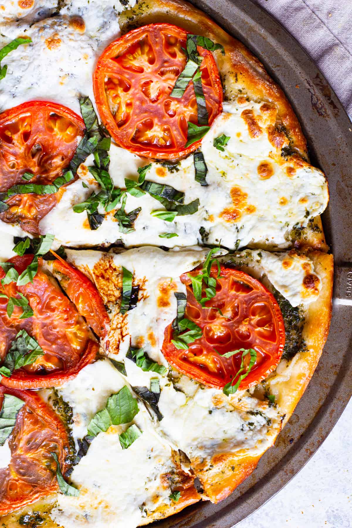 Pizza with mozzarella, tomatoes and basil.