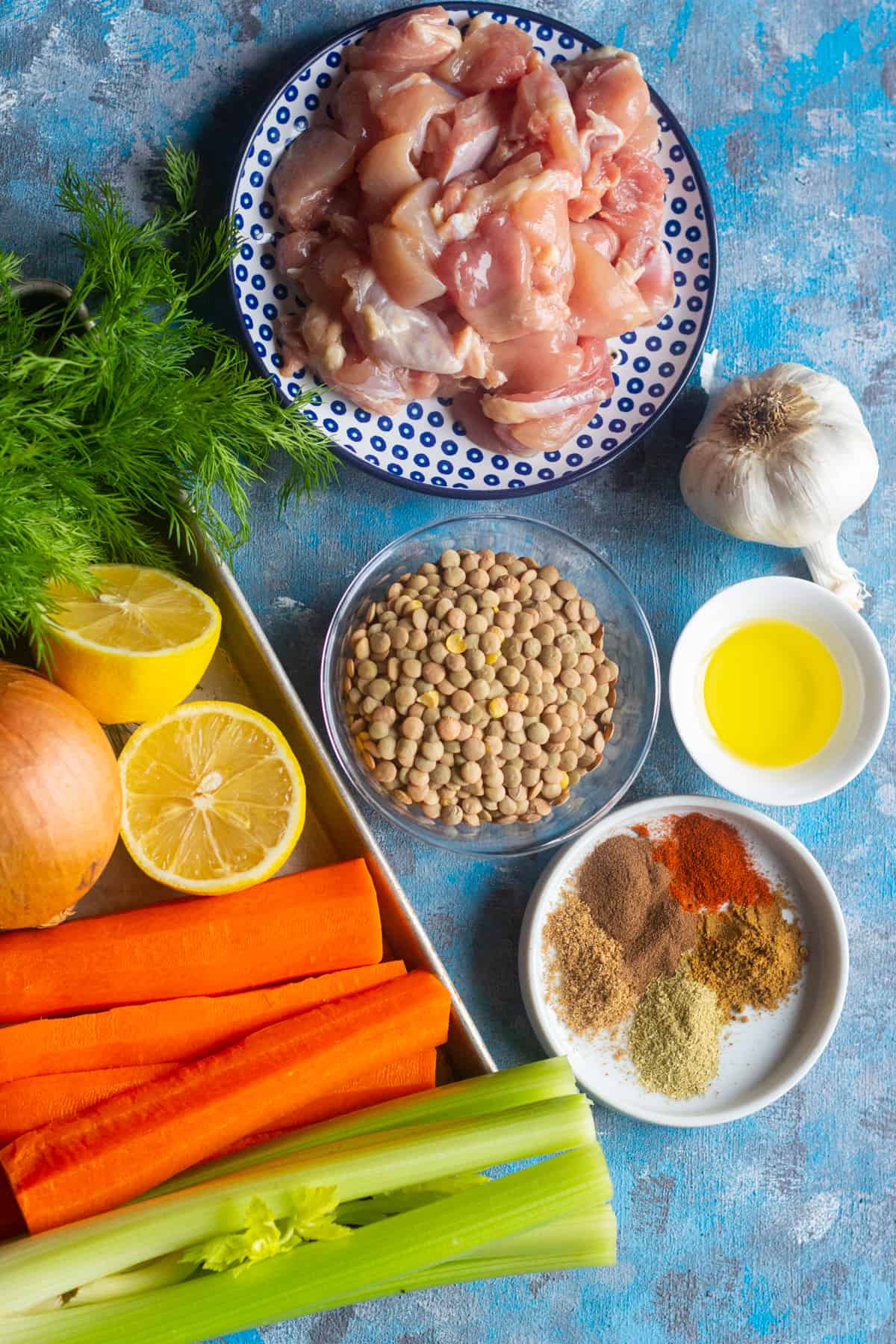 To make chicken lentil soup you need onion garlic, carrots, celery, chicken thighs, lentils and spices. 