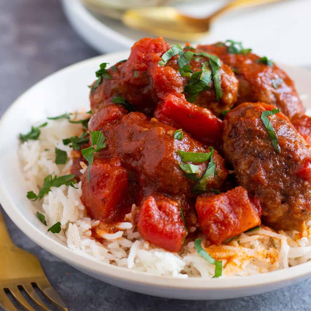Greek meatballs in tomato sauce on a bed of rice. 