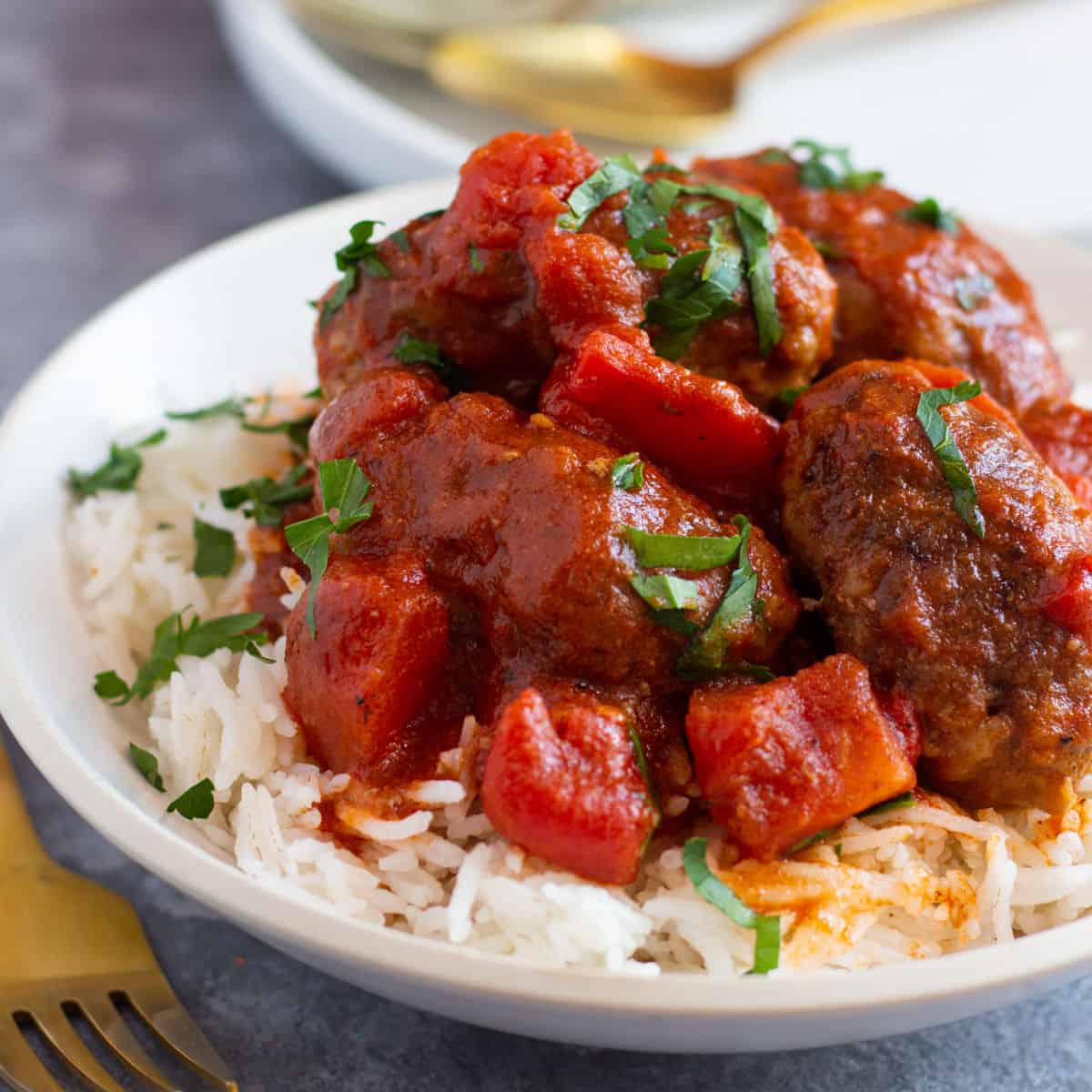 Soutzoukakia also known as Greek baked meatballs in tomato sauce is a classic recipe that's full of flavor. Juicy meatballs cooked in a flavorful rich tomato sauce makes the perfect recipe. Follow along for all my tips and tricks to make the juiciest meatballs!