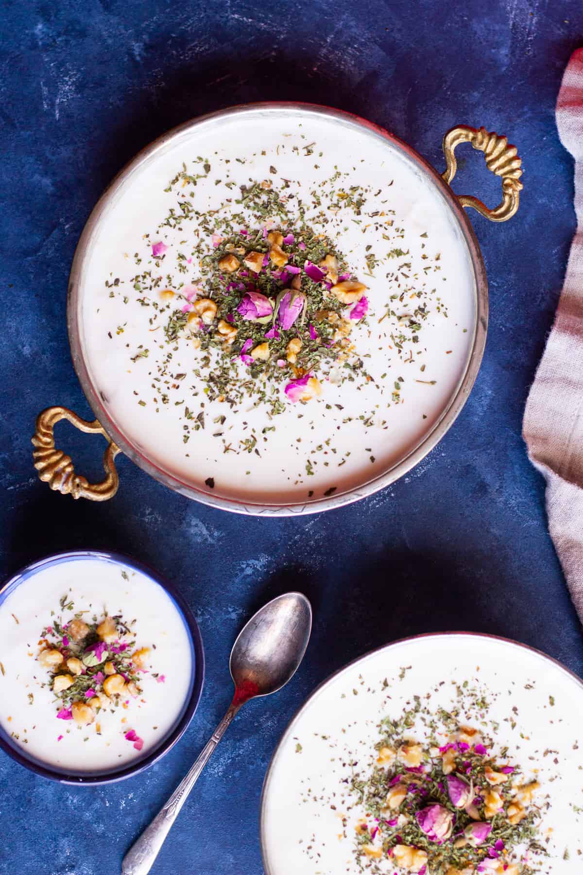 bowls of homemade yogurt topped with mint ad rose. 