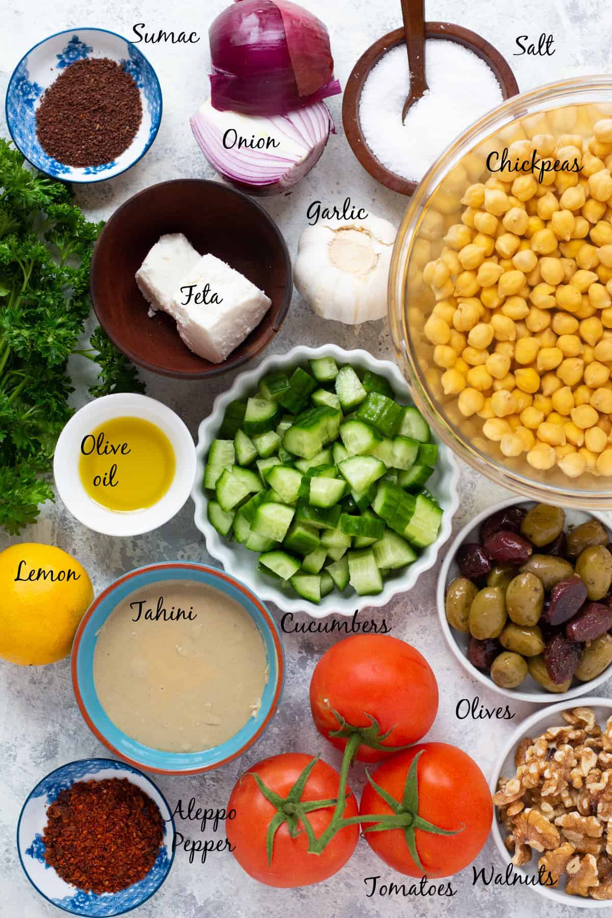For this recipe you need hummus, feta, onion, sumac, olives, cucumber, olive oil, lemon, garlic, tomato and herbs.