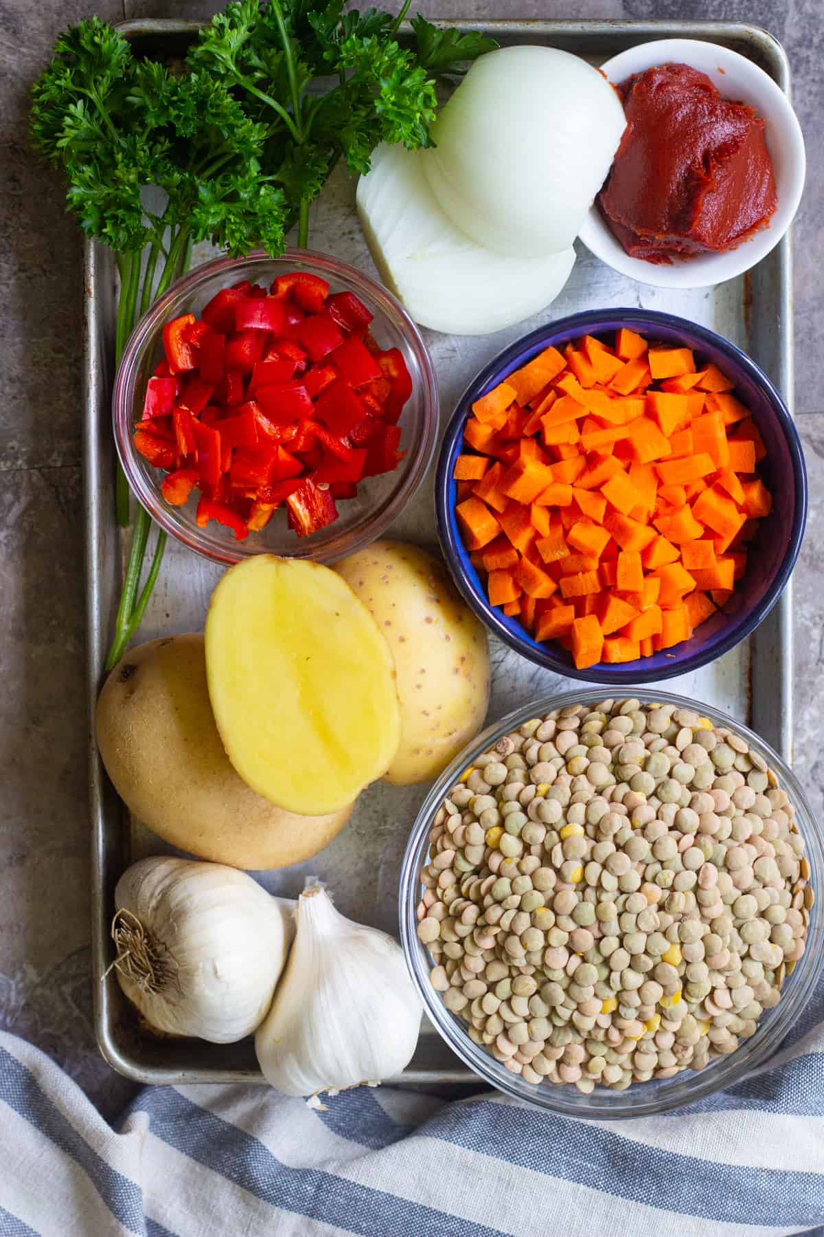 The ingredients to make this green lentil soup are lentils, carrots, onions, potatoes, garlic and spices. 