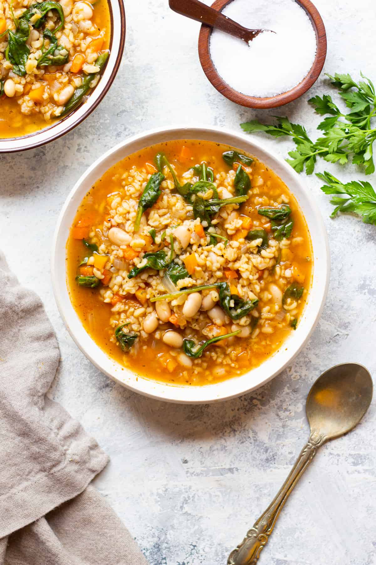Two bowls of instant pot vegetable soup. This is a vegan soup made with bulgur. 