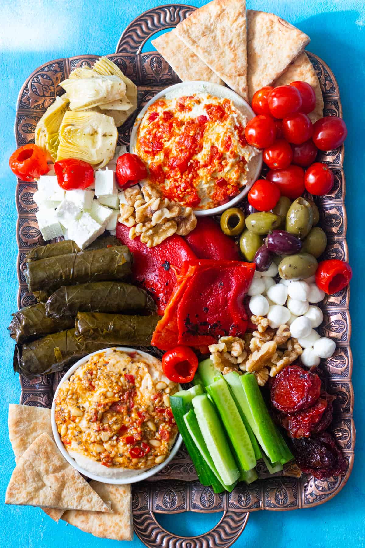 Add stuffed grape leaves, sun dried tomatoes, artichokes and olives to the Lebanese mezze platter. 