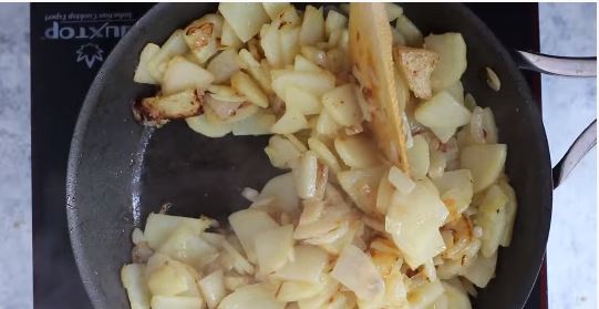 Add the potatoes and cook until they are soft and golden.