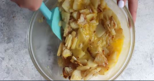 Add the potatoes and onions to the eggs.