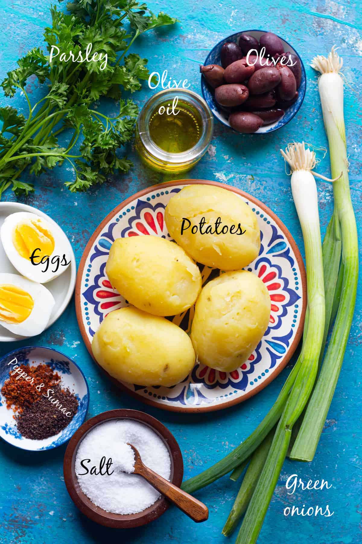 ingredients to make turkish potato salad are boiled potatoes, green onions, parsley, olives, eggs, olive oil and spices