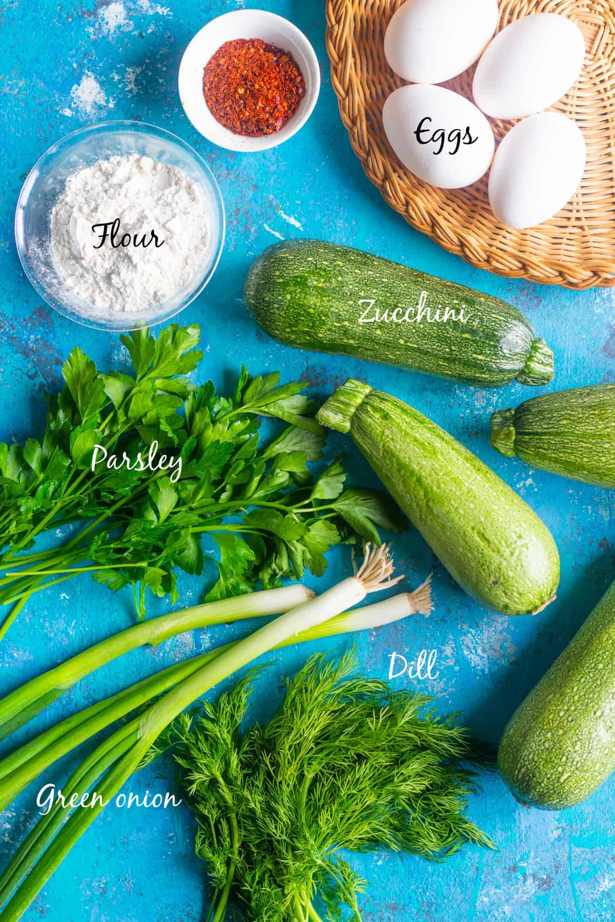 To make zucchini fritters you need zucchinis, green onion, parsley, dill, eggs, flour and Aleppo pepper. 