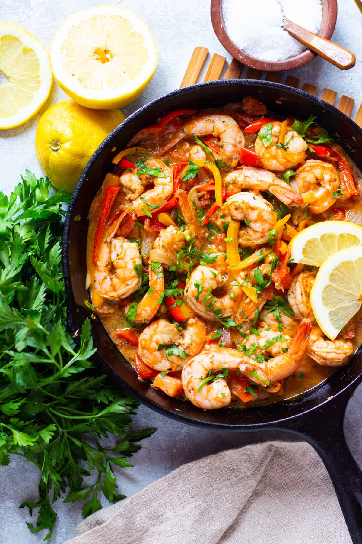 overhead shot of shrimp and vegetables in a cast iron pan. 