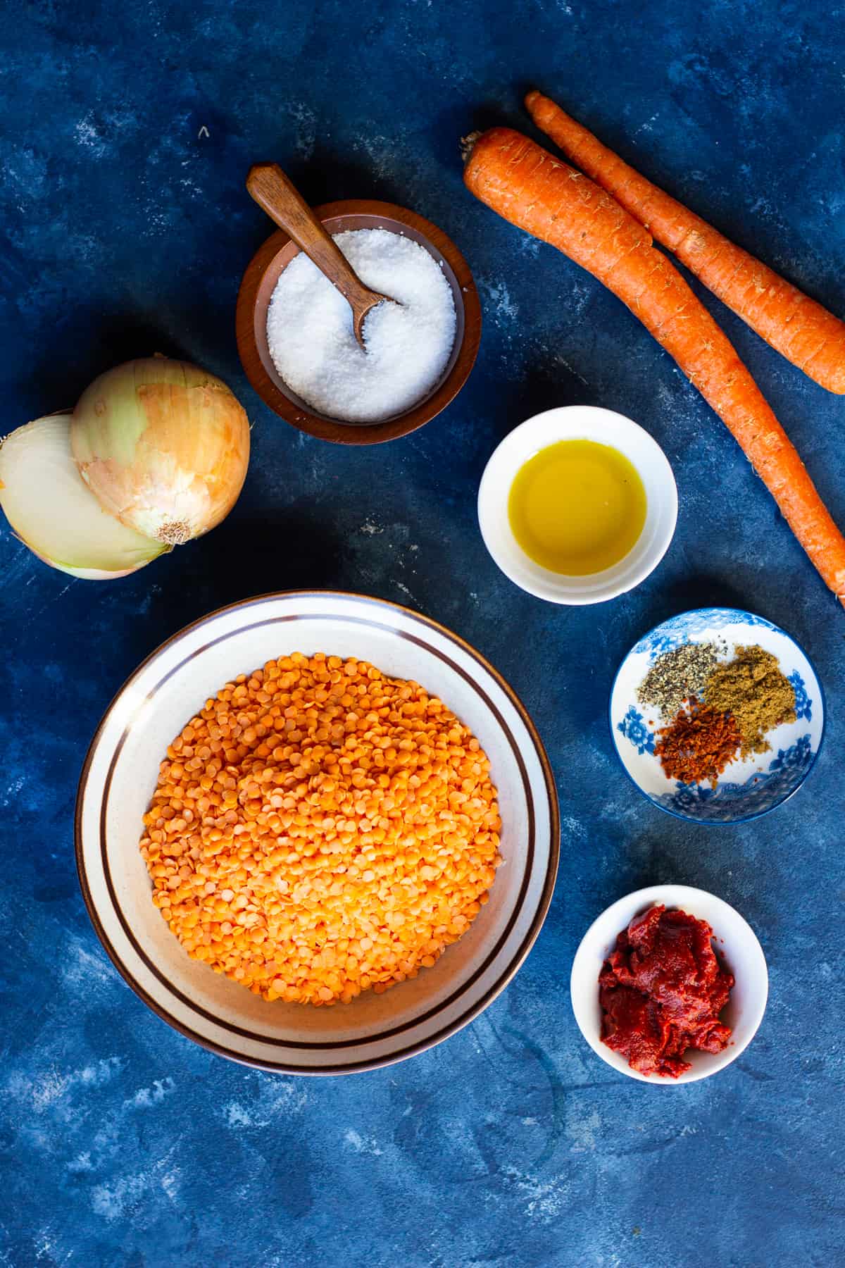 To make mercimek corbasi you need red lentils, tomato paste, spices, olive oil, onion and carrots.