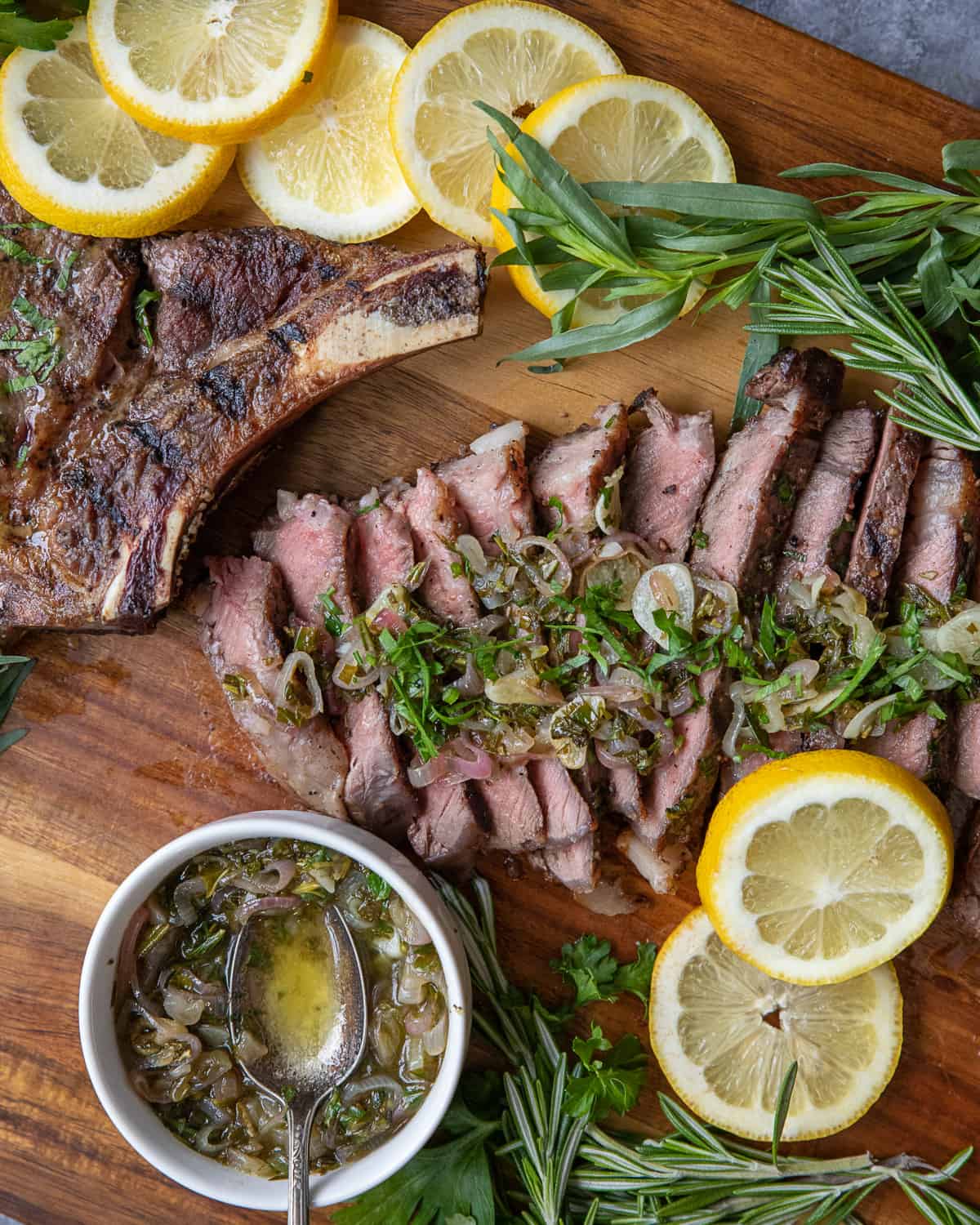 Sliced steak on a board with the sauce.