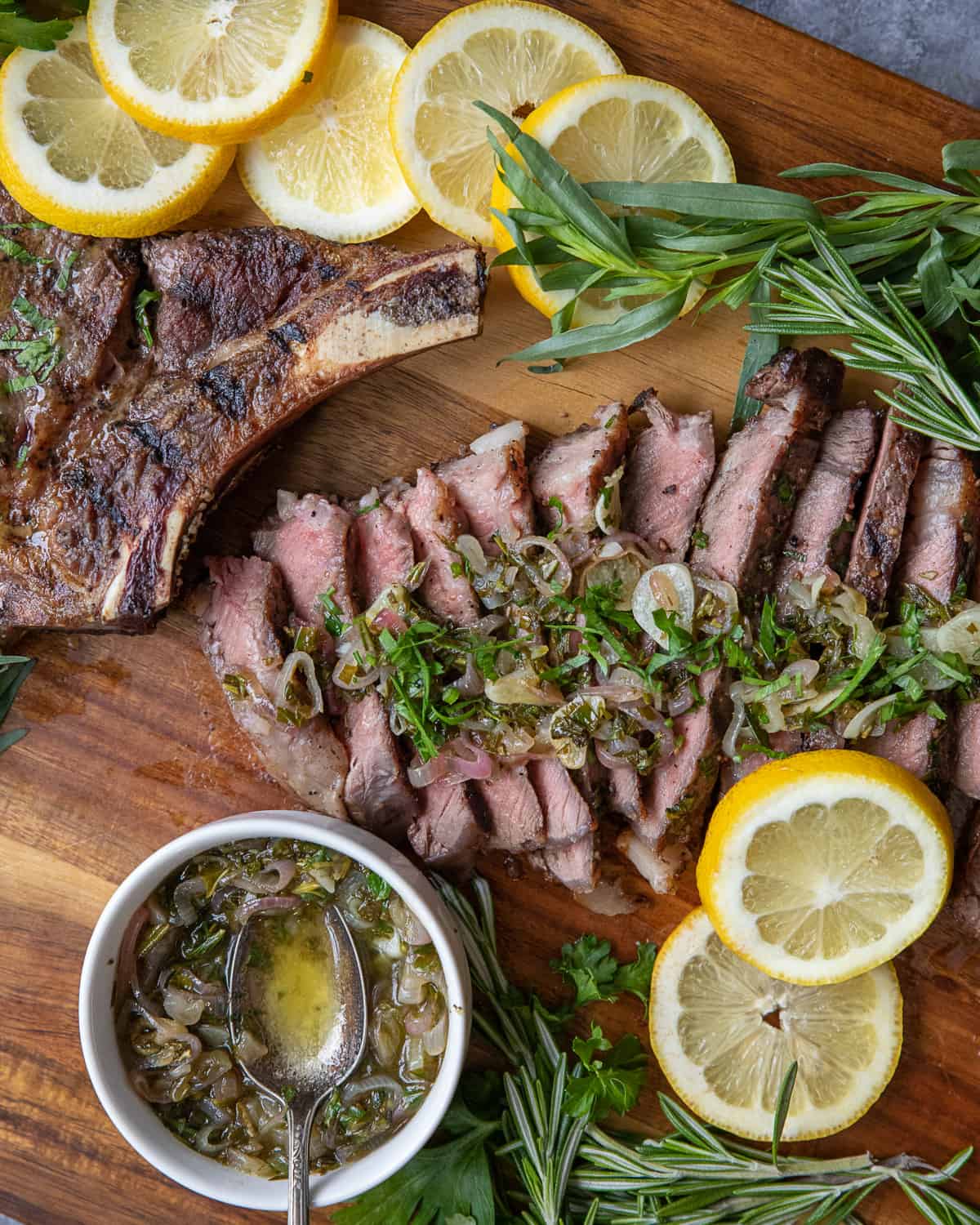 Sliced steak on a board with the sauce. 