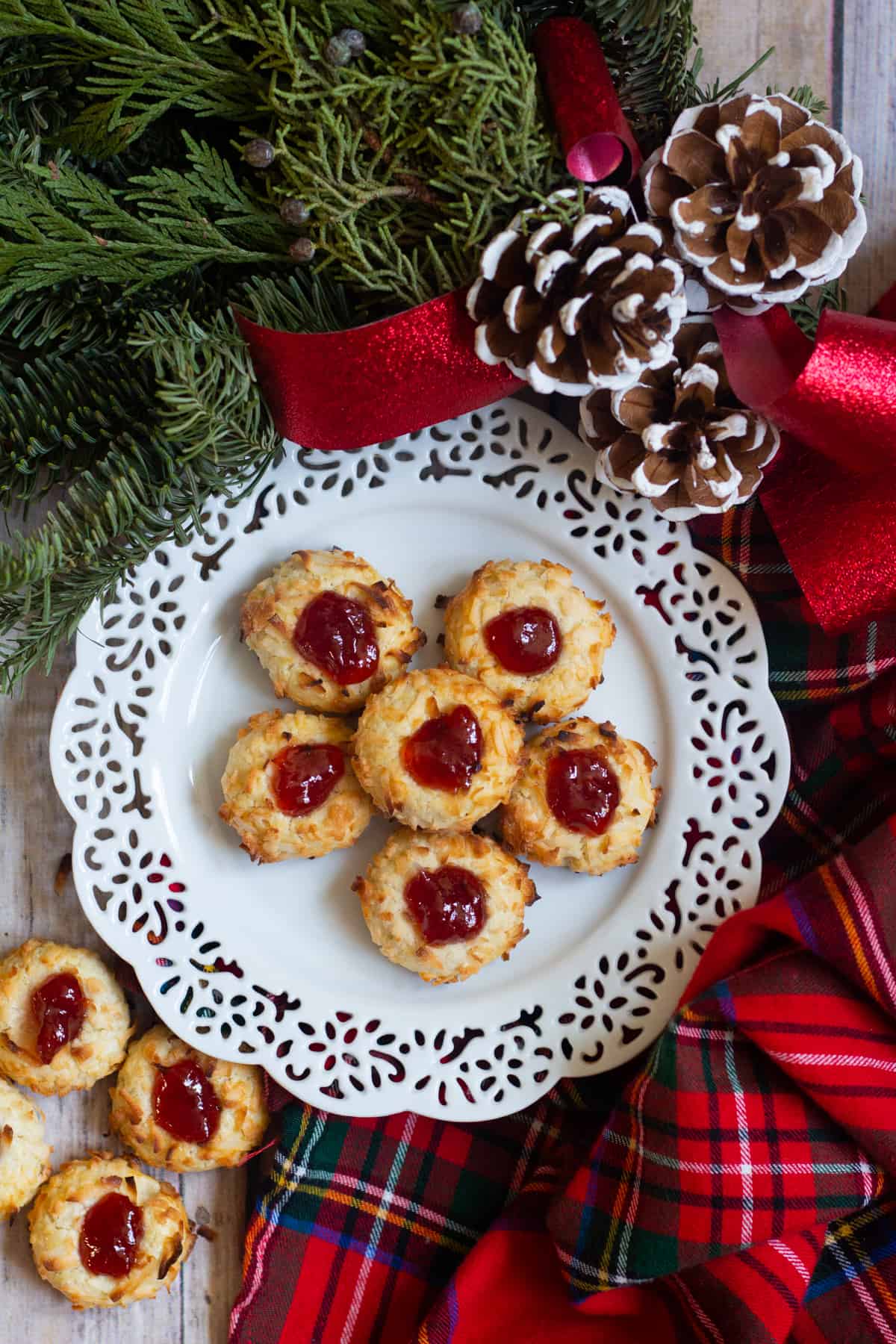 Coconut Thumbprint Cookies are a classic holiday favorite. These delicate cookies are baked to perfection and filled with delicious raspberry jam.