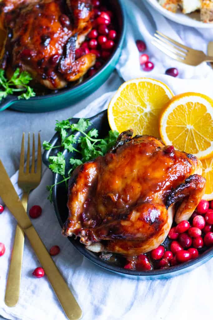 Two glazed cornish game hens with cranberry orange glaze.