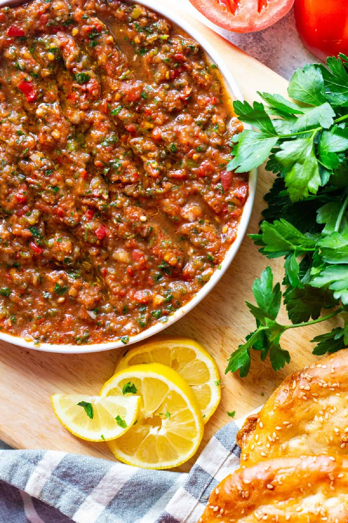 Ezme on a plate with pie bread, lemon and herbs. 