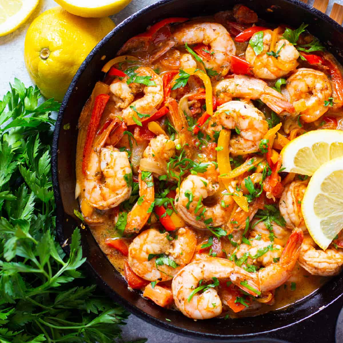 This Mediterranean style shrimp recipe is bursting with vibrant flavors. Large shrimp marinated with spices, garlic and olive oil, then cooked in a delicious tomato and pepper sauce results in one of the tastiest 20-minute dinners you'll ever find!
