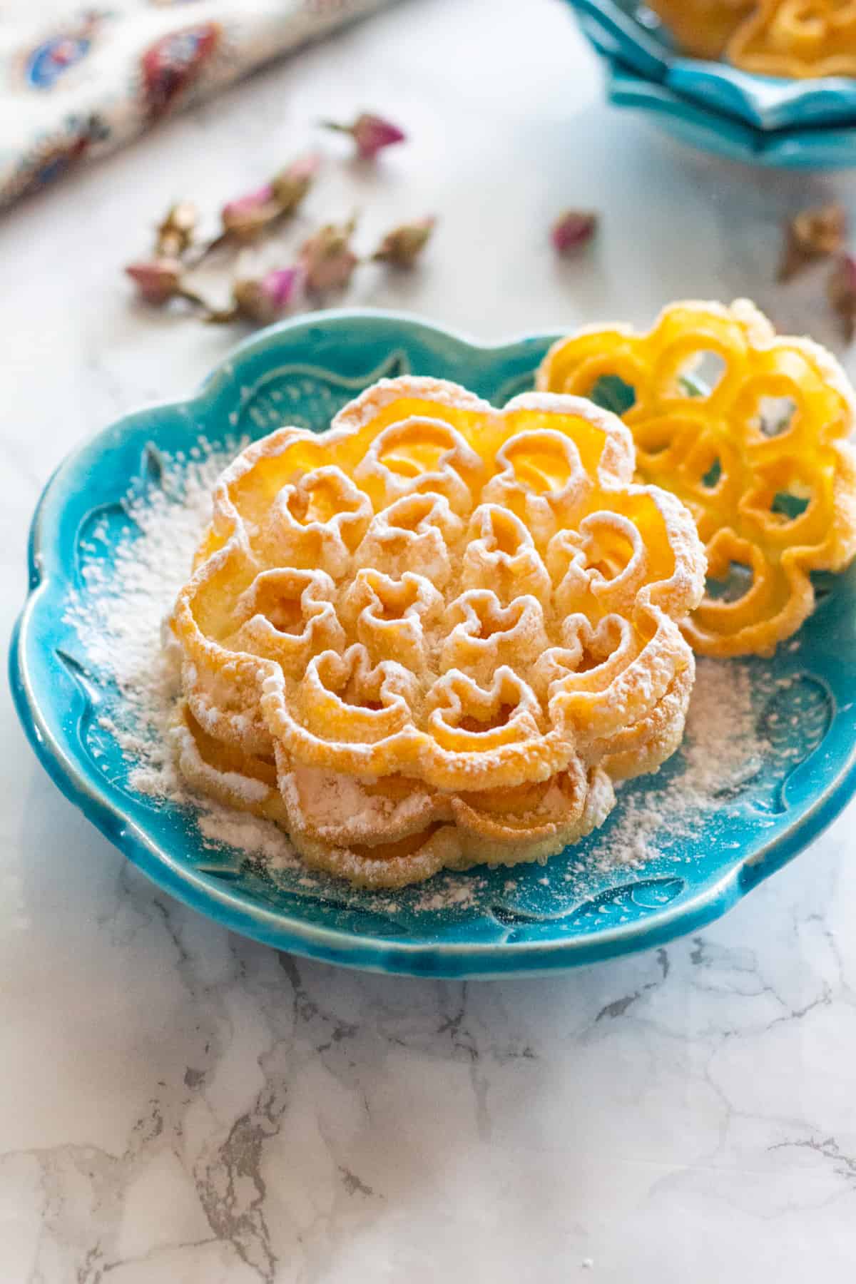 Persian rosettes topped with powdered sugar.
