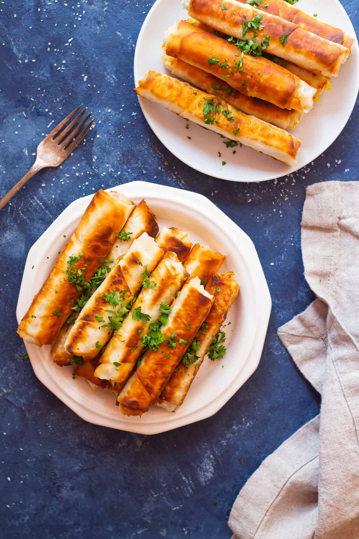 Borek is a Turkish savory crunchy pastry filled with different fillings such as cheese or potatoes. Learn how to make Turkish borek recipe by watching our step-by-step video and tutorial. They are perfect as a midday snack or for breakfast and you can make them in advance and freeze them for later. 
