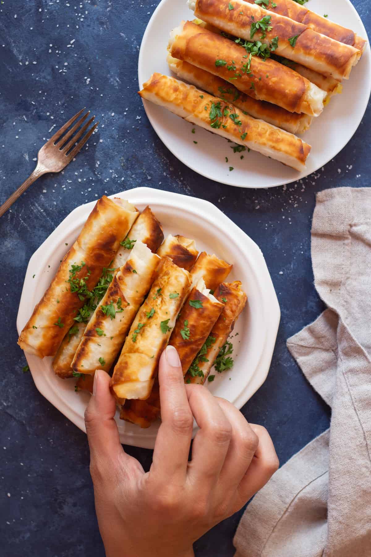 Borek is a Turkish savory crunchy pastry filled with different fillings such as cheese or potatoes. Learn how to make Turkish borek recipe by watching our step-by-step video and tutorial. They are perfect as a midday snack or for breakfast and you can make them in advance and freeze them for later. 
