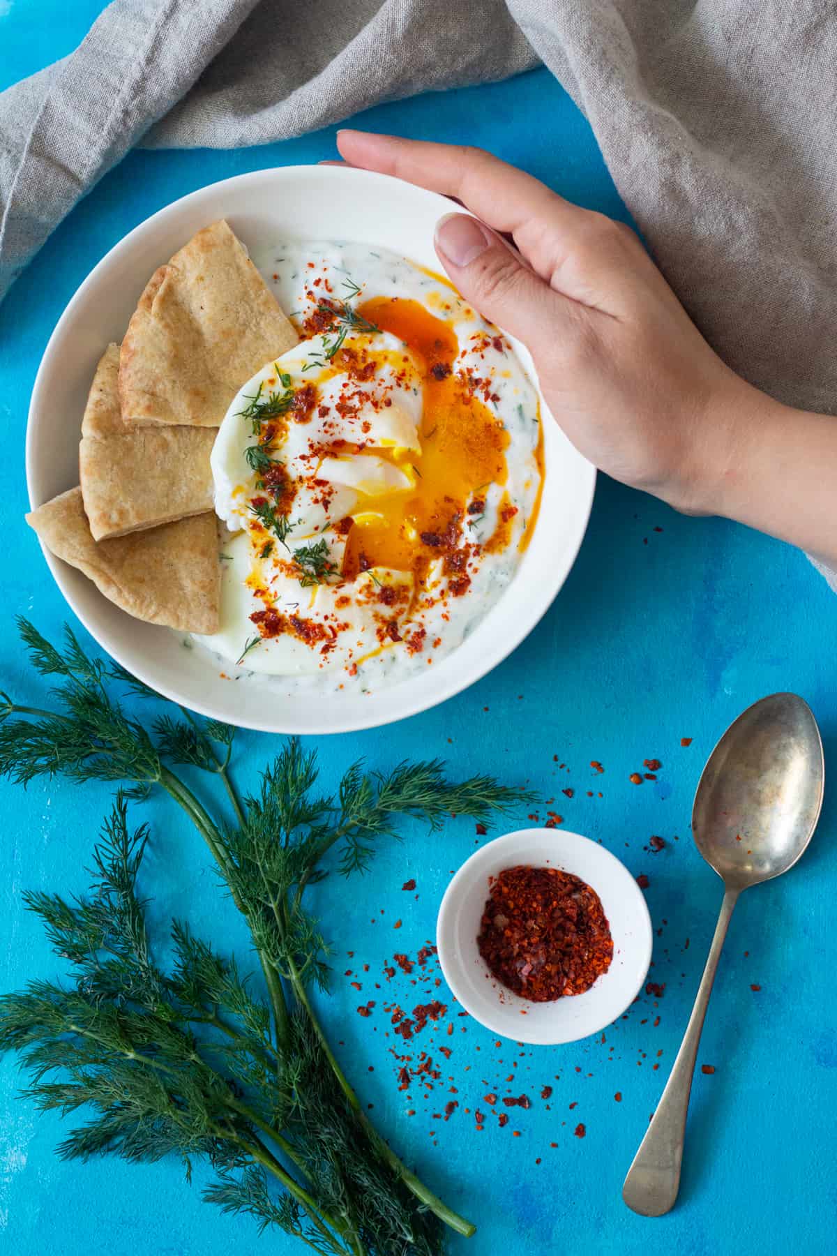 Cilbir is a complete dish on it's own. However, I always enjoy a slice of toasted bread like sourdough with it. Turkish eggs can also be served with warm lavash or pita bread.
