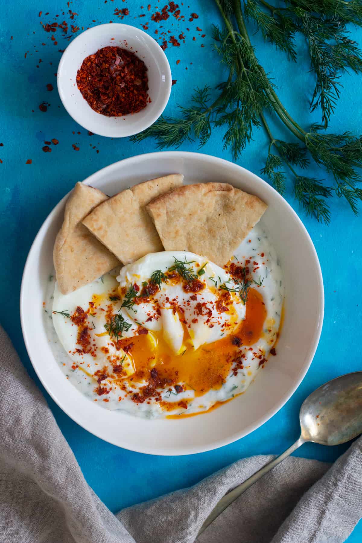 Cilbir is a delicious Turkish breakfast made with poached eggs and a flavorful yogurt sauce, ideal for a hearty brunch.
