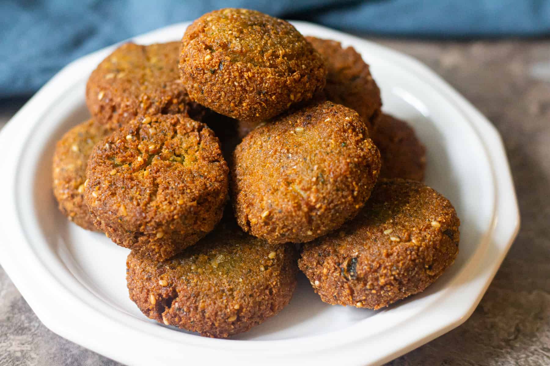 Fry homemade falafel in oil util golden brown on all sides. These vegan chickpea patties ate crispy on the outside and tender on the inside.