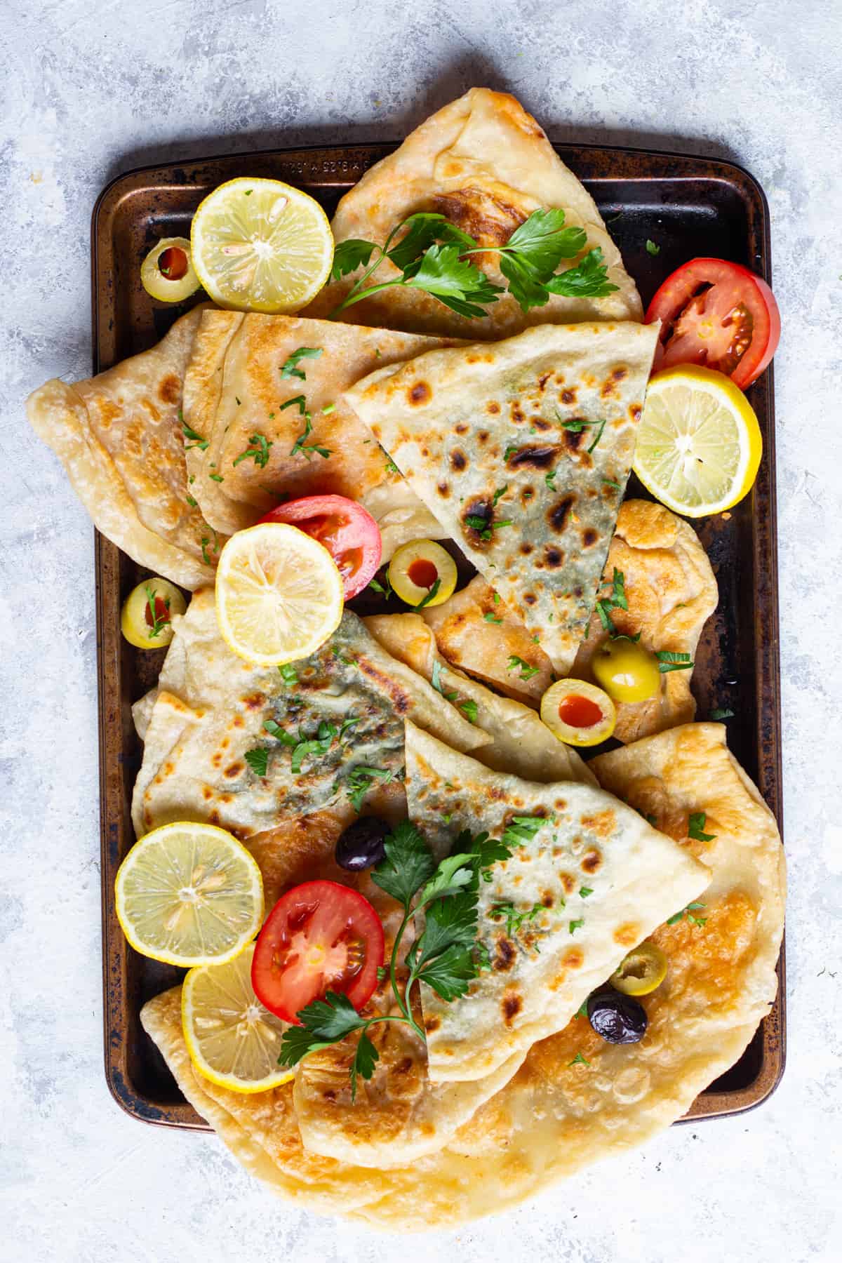 Cut turkish flatbread gozleme into triangles for better grab. 
