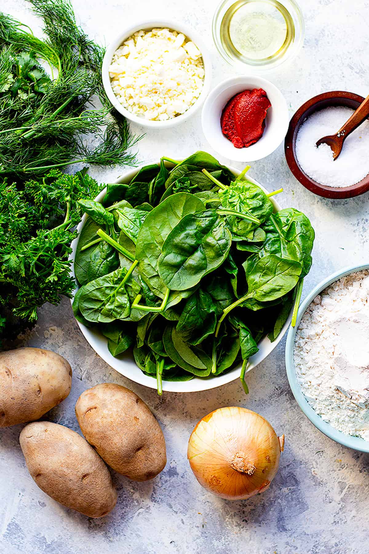 to make turkish flatbread you need potatoes, spinach, flour, oil, cheese, greens and tomato paste.